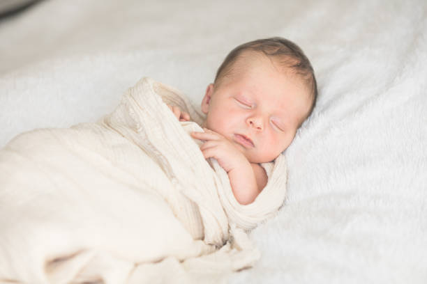 istock Cute baby sleeping 5 days old on light blanket. Banner design with space for text 1695669184
