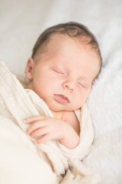 istock Cute baby sleeping 5 days old on light blanket. Banner design with space for text 1695669196
