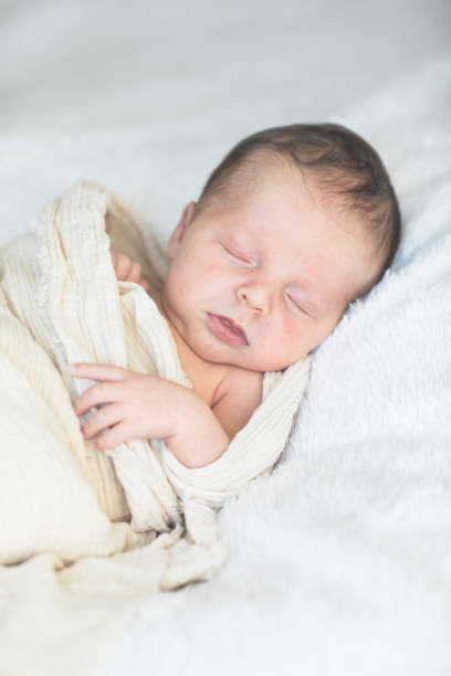istock Cute baby sleeping 5 days old on light blanket. Banner design with space for text 1695669197