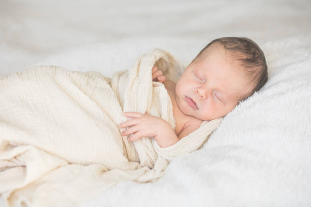 istock Cute baby sleeping 5 days old on light blanket. Banner design with space for text 1695669246
