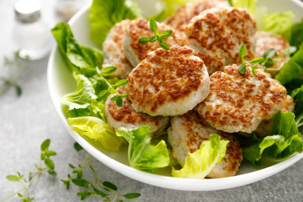 istock Chicken patties, cutlets with fresh salad 1695688025