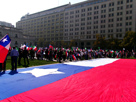 Chilean flag and people protesting