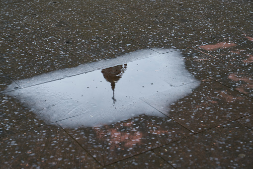 Reflection of church steeple in Mexico in puddle of water