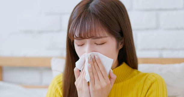 istock woman sick and sneezing 1695748528