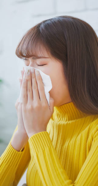 istock woman sick and sneezing 1695749028