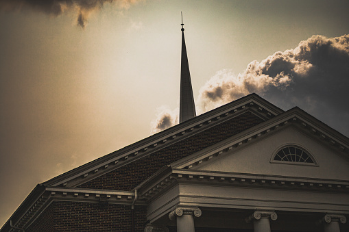 Historic Christian church in south Atlanta, Georgia backlit behind glowing steeple