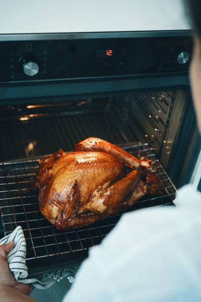 istock Roasting Turkey in the Oven for Holiday Dinner 1695757373