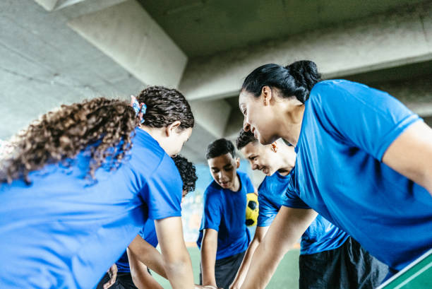 istock Soccer team with hands clasped on the soccer field 1695786843