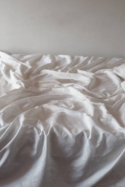 istock messy bed in early morning , messy bed after waking up 1695788484