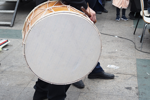 A man hit the ancient drum with Musical Instrument