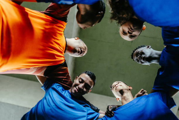 istock Soccer team huddling on the soccer field 1695797942