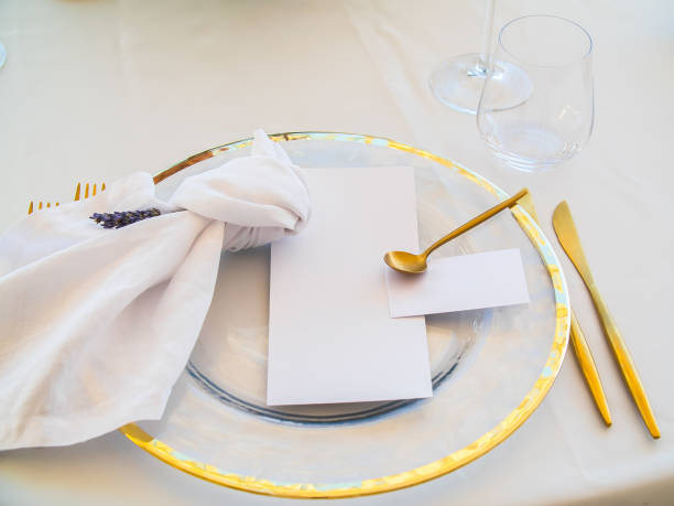 istock Wedding Table place with invitation card and porcelain plates decorated with olive branches top view. Elegant modern template with square blank paper card flat lay. Mediterranean mockup, copy space 1695800832