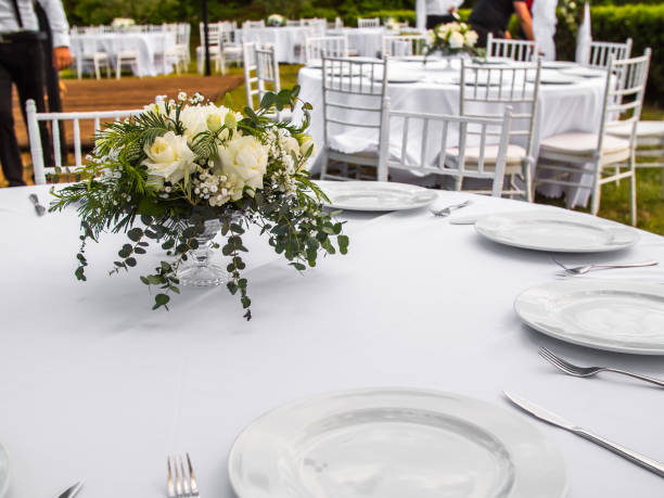 istock Table at luxury wedding reception event. Beautiful flowers on table and serving dishes and glasses and decoration 1695801421