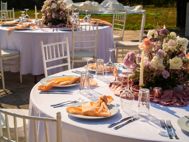 istock Table at luxury wedding reception event. Beautiful flowers on table and serving dishes and glasses and decoration 1695803731