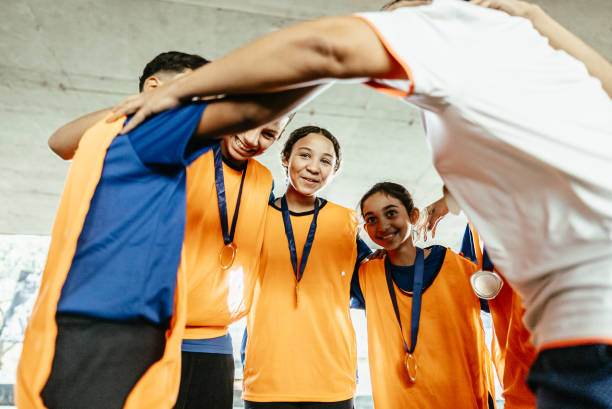 istock Soccer team huddling after win the soccer match 1695807871