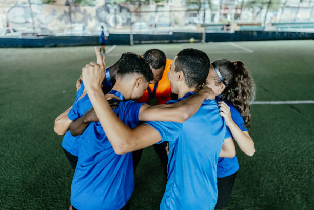 istock Soccer team huddling after win the soccer match 1695808432