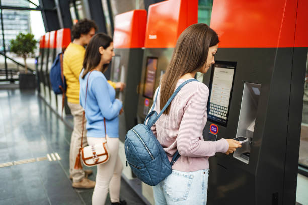 istock Three passengers buying train tickets at the train station 1695858144