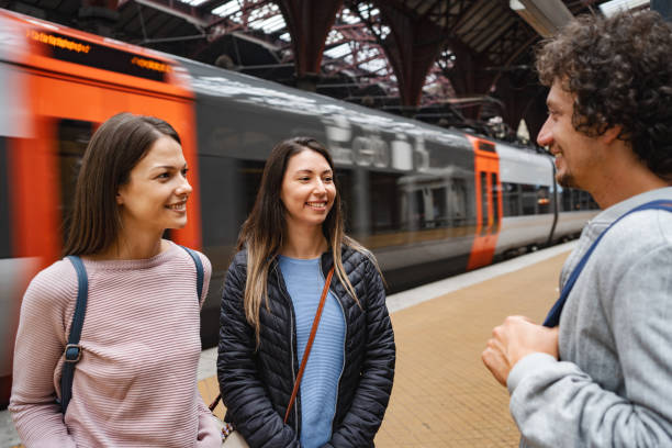 istock Three friends talking while waiting on the train station 1695858635