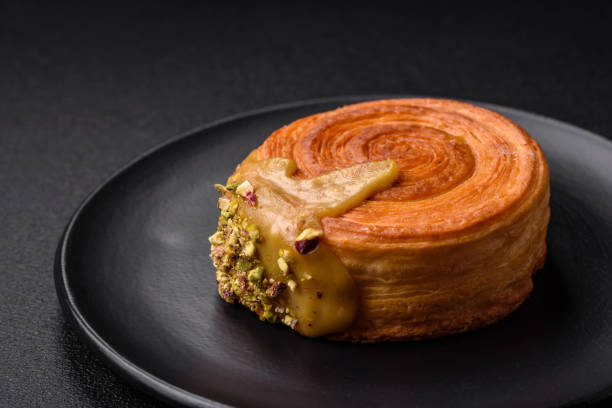istock Round puff pastry croissant with raspberry filling or new york roll 1695864214