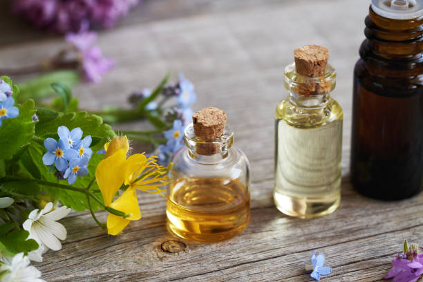 istock Essential oils with colorful flowers on a table 1695882734