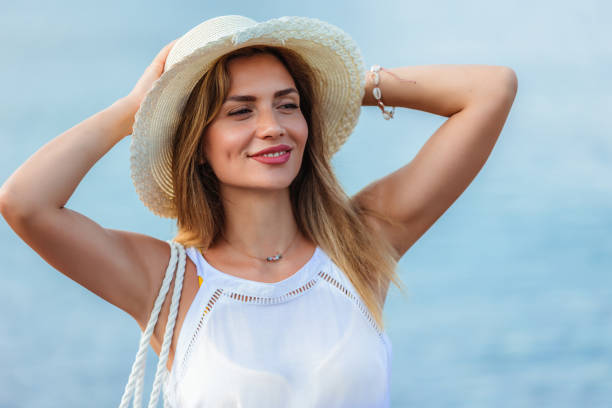 istock Happy young beautiful woman walking alone on the beach 1695883098