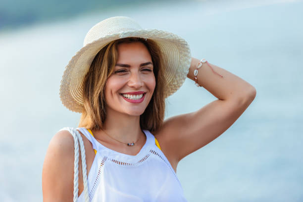 istock Happy young beautiful woman walking alone on the beach 1695883109