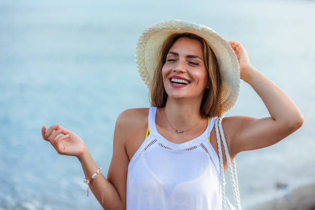 istock Happy young beautiful woman walking alone on the beach 1695883119