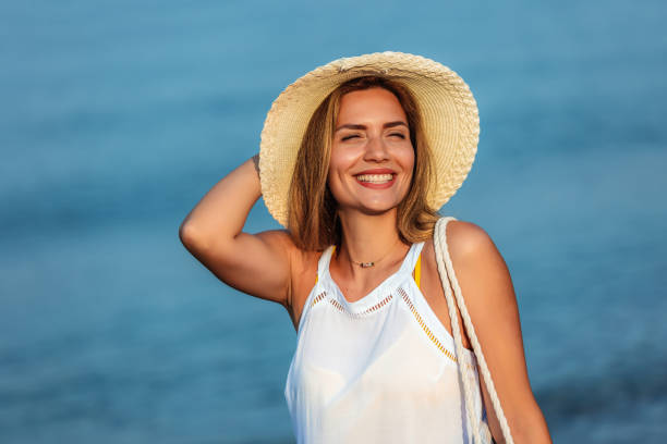 istock Happy young beautiful woman walking alone on the beach 1695883126