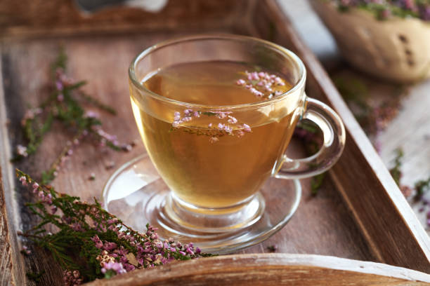 istock Herbal tea in a glass cup with fresh heather flowers 1695883153