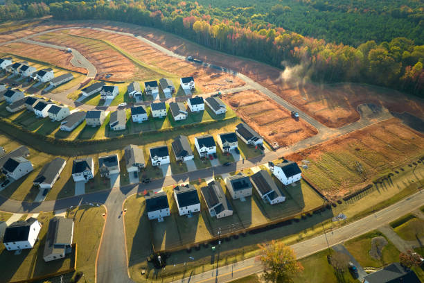 Ground prepared for building of new residential houses in South Carolina suburban development area. Concept of growing american suburbs Ground prepared for building of new residential houses in South Carolina suburban development area. Concept of growing american suburbs. basement construction site construction blueprint stock pictures, royalty-free photos & images