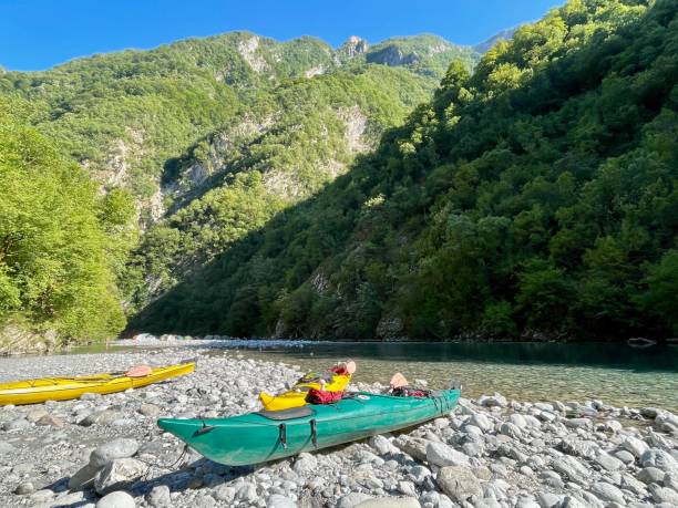 istock Canoes on shore at Shala river, Albania. 1695894428