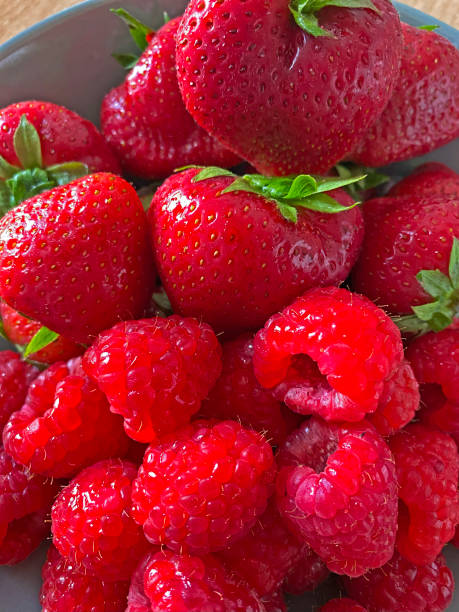 istock fresh ripe strawberries on a white plate 1695898311