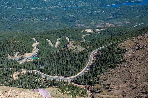 Curves on steep Pikes Peak highway to the summit of America's Mountain (elevation 14115 feet) in the Rocky Mountains in central Colorado in western USA of North America. Nearby cities are Colorado Springs, Denver and Pueblo, Colorado.