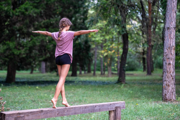 istock a little girl walks on a beam 1695975012