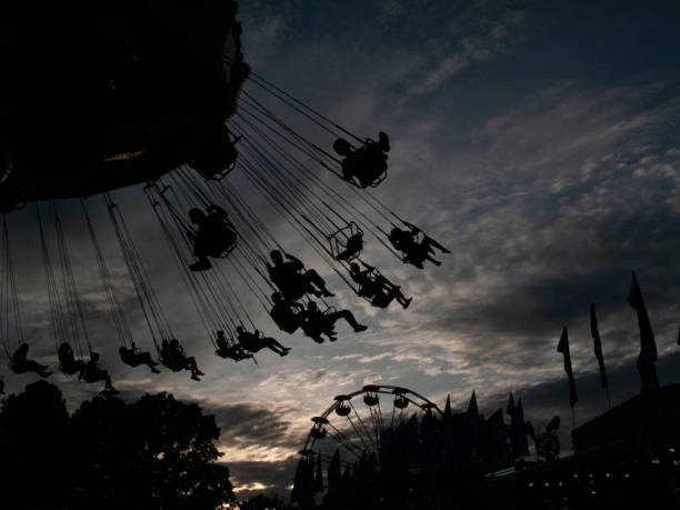 istock Swing ride in silhouette at county fair 1695976605