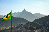 The Brazilian Flag, the Corcovado Mountain and the Favela in Morro da Babilônia, seen from Forte Duque de Caxias (Forte do Leme) - Rio de Janeiro, Brazil