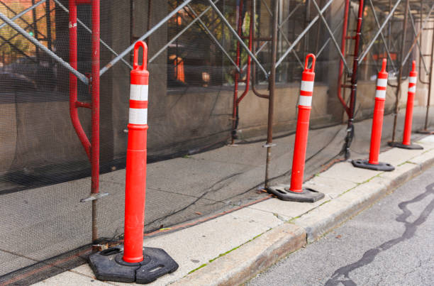 istock orange construction cone on urban street, symbolizing road safety, caution, and ongoing infrastructure work, with blurred cityscape in background 1695996168