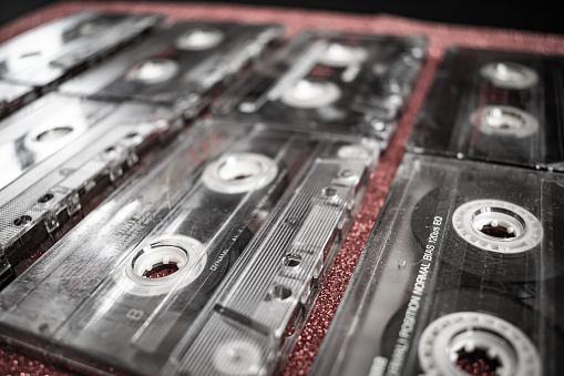 Close-up shot of a set of vintage retro audio tapes on red background.