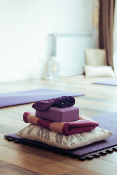 istock Empty yoga studio interior with mats and accessories. Copy space. Vertical shot. 1696018665