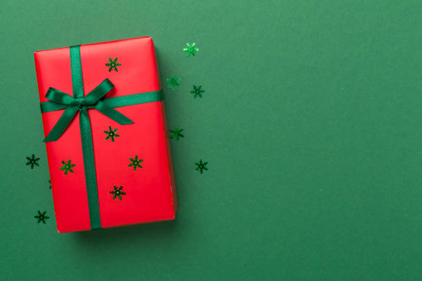 istock Creative handmade christmas gift box with decor on color background, top view 1696028817