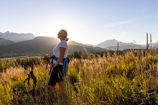 She looks off to distant mountains in distance, Crowsnest Pass, Alberta