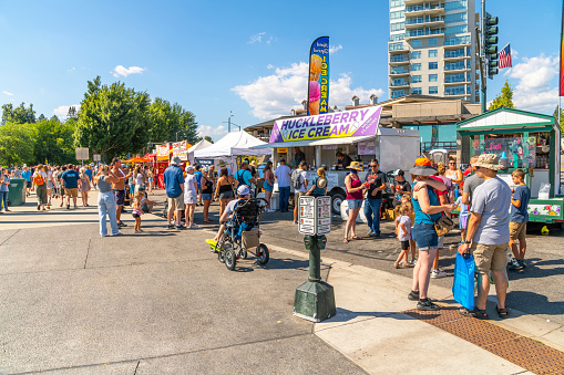 The annual Arts and Crafts Street Fair with vendors selling food, gifts and art products along main street Sherman Avenue, and through city park in the lakefront tourist resort town of Coeur d'Alene, Idaho.