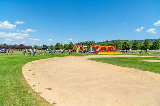 Families play at Pavilion Park during a summer festival and fair in the Spokane Washington suburb of Liberty Lake, Washington. Liberty Lake is a city in Spokane County, Washington, United States located adjacent to the eponymous lake. Located just over a mile west of the Washington–Idaho border, Liberty Lake is both a suburb of Spokane, Washington and a bedroom community to Coeur d'Alene, Idaho.