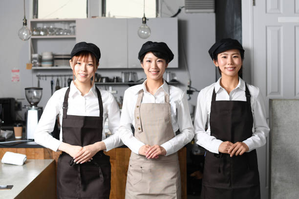istock Several smiling young Asian women wearing aprons working at a restaurant 1696089340