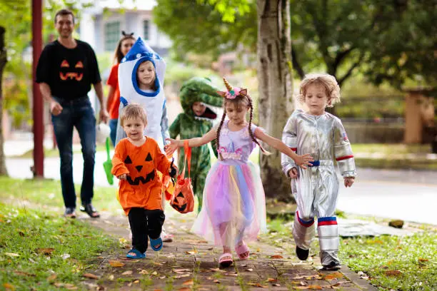 Photo of Kids trick or treat. Halloween fun for children.