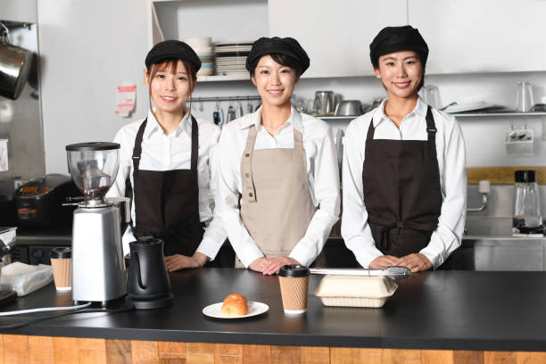 istock Several smiling young Asian women wearing aprons working at a restaurant 1696128429
