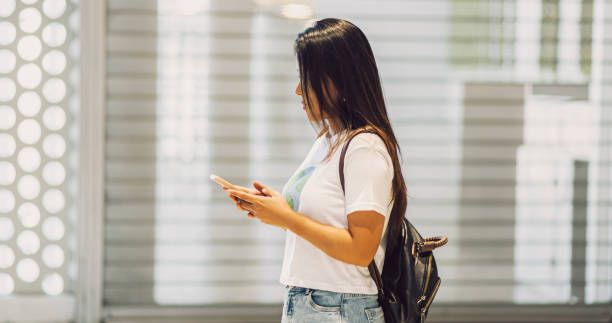 istock young, pretty, casual, in a business environment, using the phone. Space for text. 1696155149