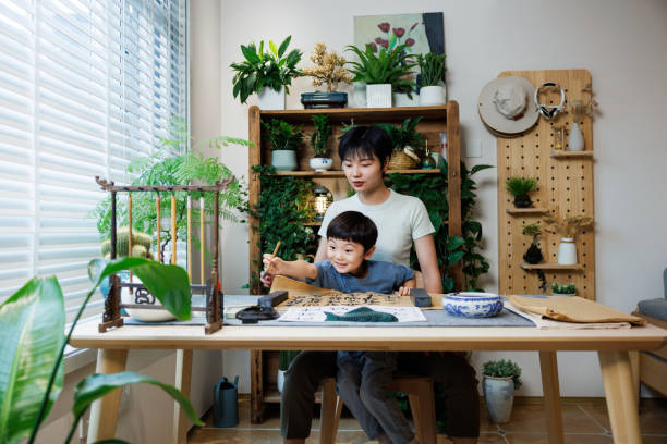 istock mother and son learn calligraphy at home 1696163141