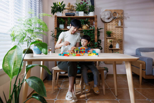 istock young mom is playing building blocks with her son at home 1696163272