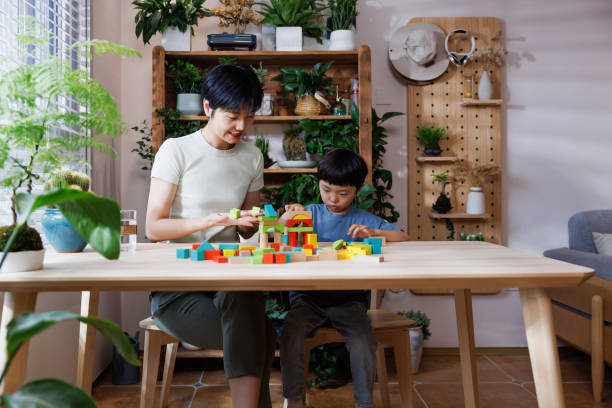 istock young asian mom is playing building blocks with her son at home 1696163274